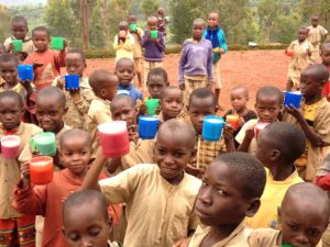 Children receiving nutritious drink so that they might have enough energy for success in school.